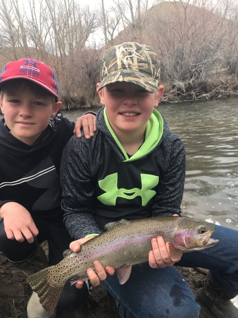 Two young boys with rainbow trout